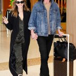 Delta Goodrem in a Black Coat Arrives at Sydney Domestic Airport with Matthew Copley in Sydney 05/10/2023