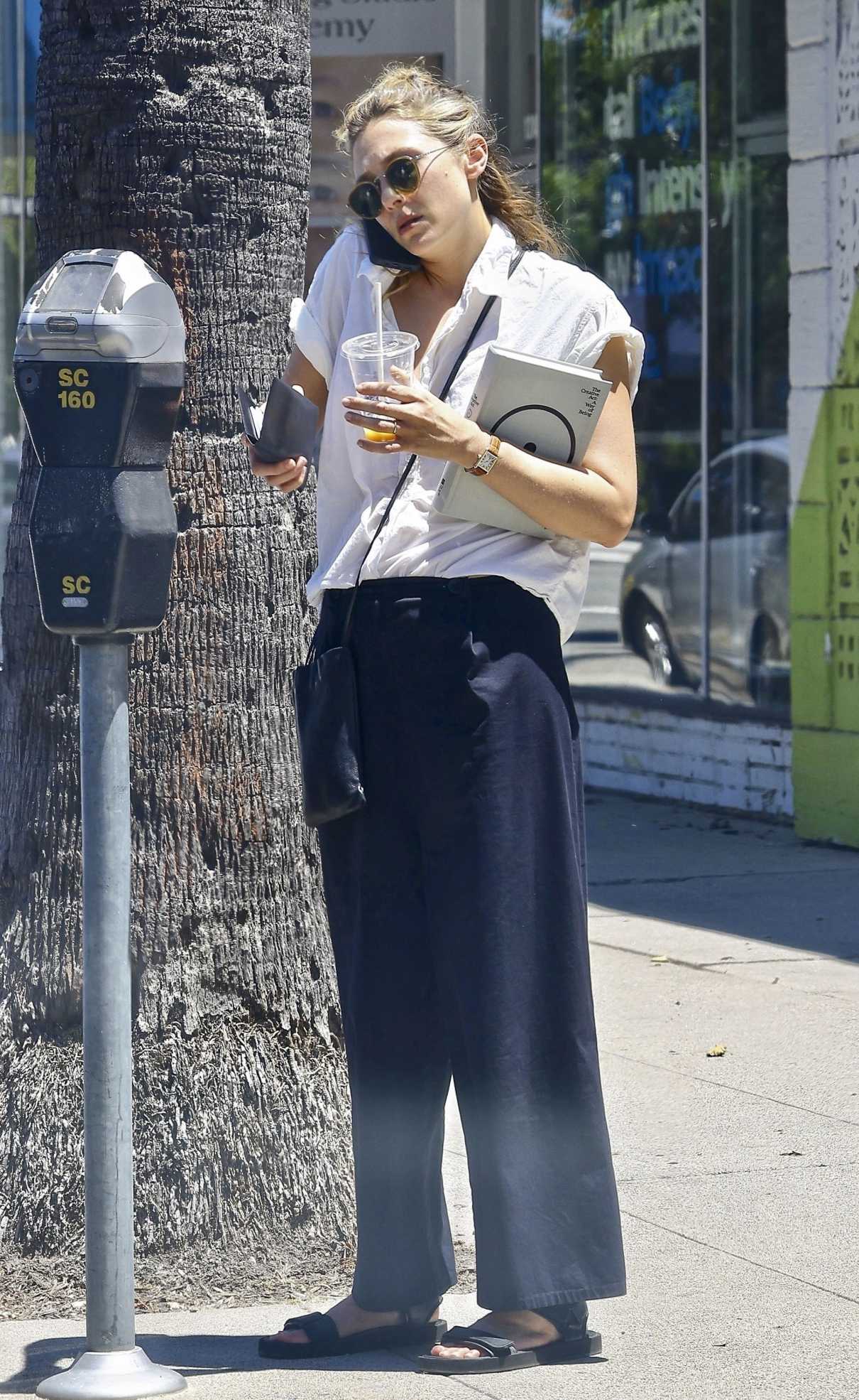 Elizabeth Olsen in a Black Pants Stops by a Book Store in Studio City ...