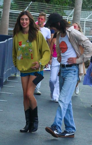 Rainey Qualley in a Blue Mini Skirt Arrives with a Friend for Taylor