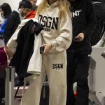 Arabella Chi in a White Sweatsuit Arrives at Airport in Manchester 01/01/2024
