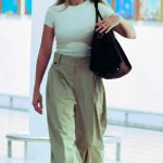 Margot Robbie in a White Tee Arrives at Brisbane International Airport in Brisbane 02/03/2024