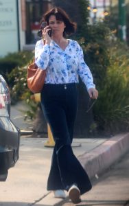Neve Campbell in a White Floral Print Blouse