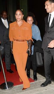 Alex Scott in an Orange Ensemble