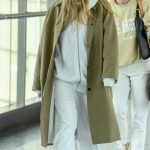 Dakota Fanning in an Olive Trench Coat Arrives at Heathrow Airport in London 05/27/2024