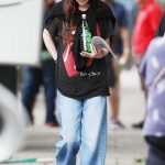 Dakota Johnson in a Black Rolling Stones Graphic Tee Arrives at Her Trailer on the Set of Materialists in Brooklyn in New York 05/30/2024