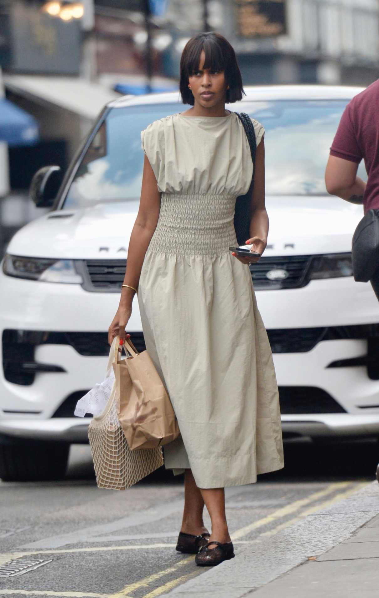 Sabrina Dhowre in a Beige Dress