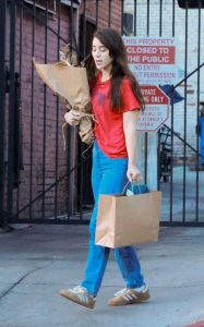 Caylee Cowan in a Red Tee Doing Some Christmas Shopping Out with Casey Affleck in Los Feliz 12/21/2024