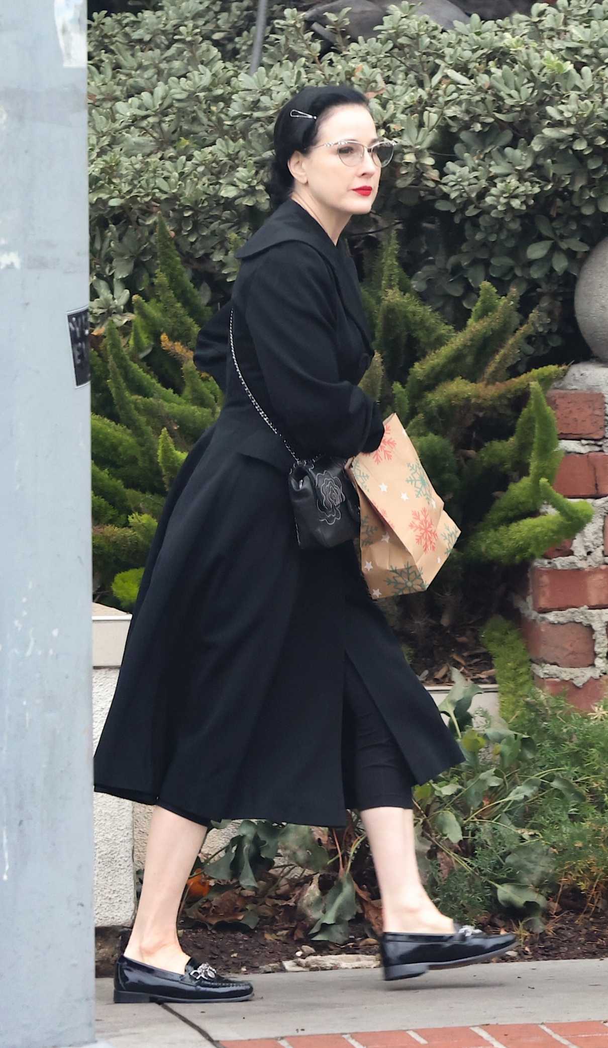 Dita Von Teese in a Black Coat