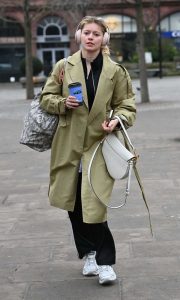 Tasha Ghouri in an Olive Trench Coat