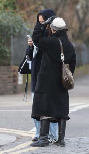 Taylor Russell in a Black Coat