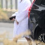 Madelyn Cline in a White Bathrobe on the Set of Day Drinker in Barcelona 05/03/2025