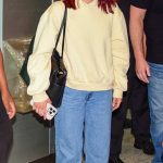 Camila Mendes in a Yellow Hoodie Arrives with Rudy Mancuso at the Airport in Sao Paulo 12/04/2025