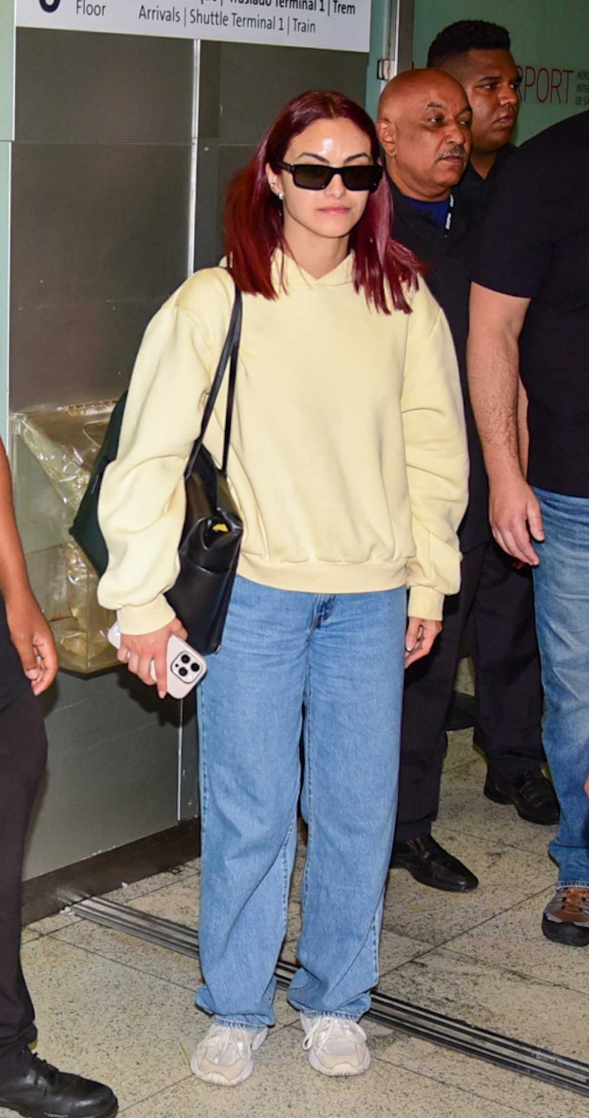 Camila Mendes in a Yellow Hoodie