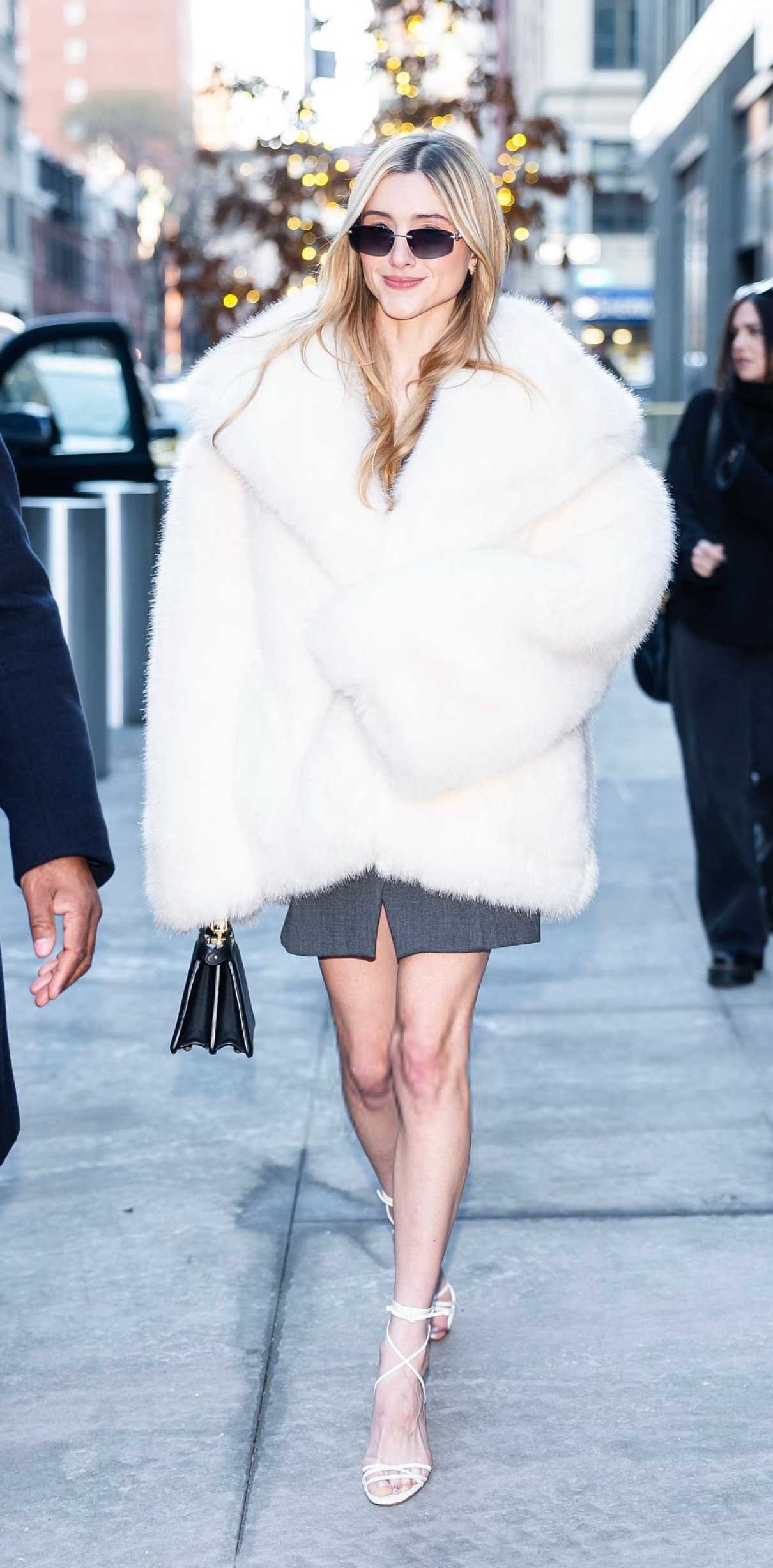 Natalia Dyer in a White Fur Coat