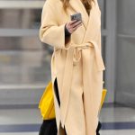 Jennifer Lawrence in a Yellow Coat Arrives at JFK International Airport in New York City 01/28/2026