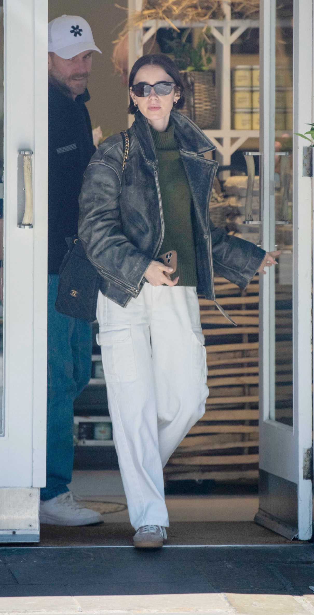 Lily Collins in a Black Leather Jacket