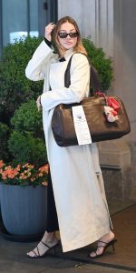 Madelyn Cline in a White Trench Coat
